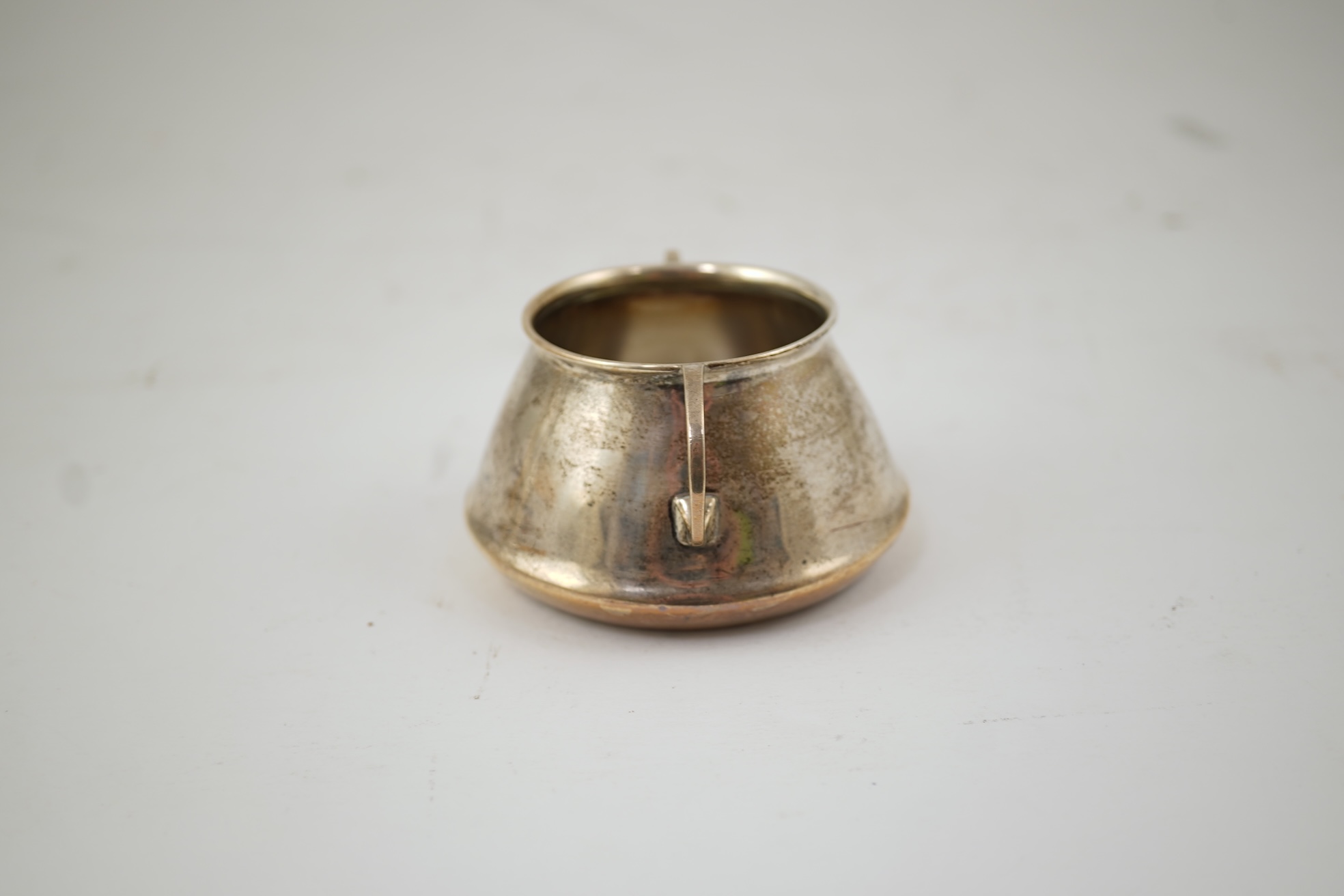 An Edwardian silver bachelor's two handled sugar bowl and matching sugar tongs, by Liberty & Co
